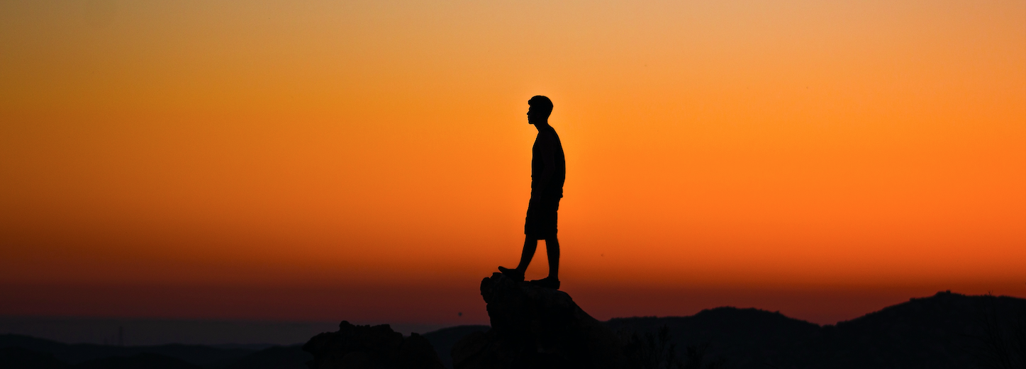 man silhouetted in a sunset